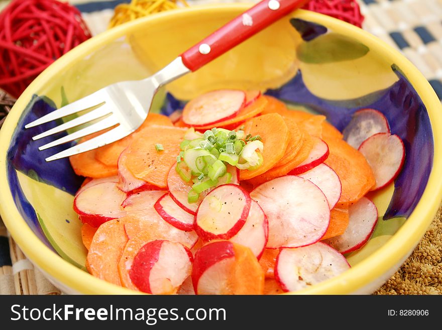A fresh salad of carrots and red radish