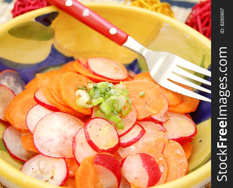 A fresh salad of carrots and red radish