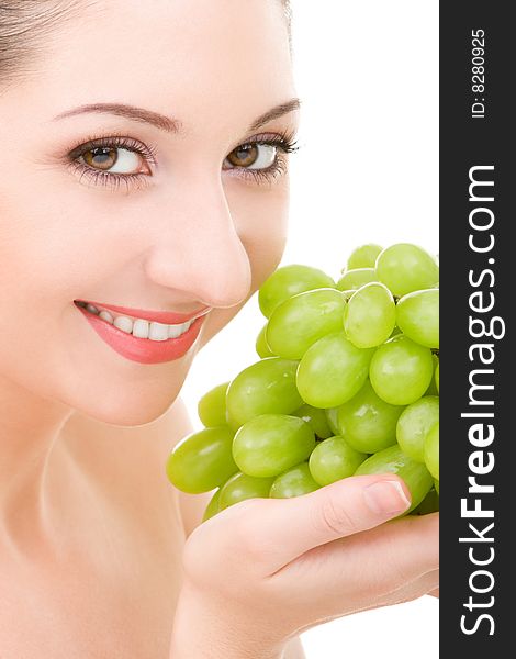 Pretty woman with green grape isolated on the white background