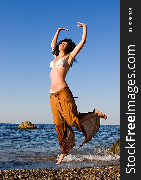 Happy young woman dance in the beach. Happy young woman dance in the beach