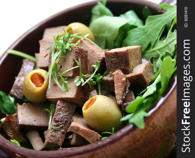 Some fresh liver meat with onions and a salad