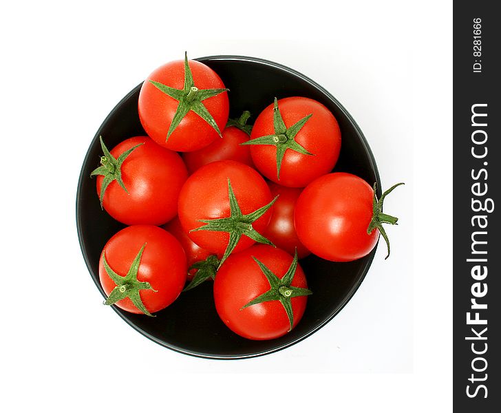 Tomatoes in a black bowl from above. Tomatoes in a black bowl from above