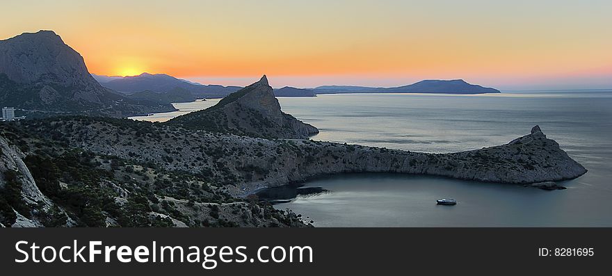 Mountain cape at sunrise. waterscape