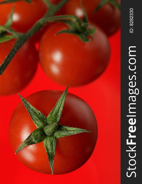 Image of tomatoes on a red background - shallow DOF (sRGB)