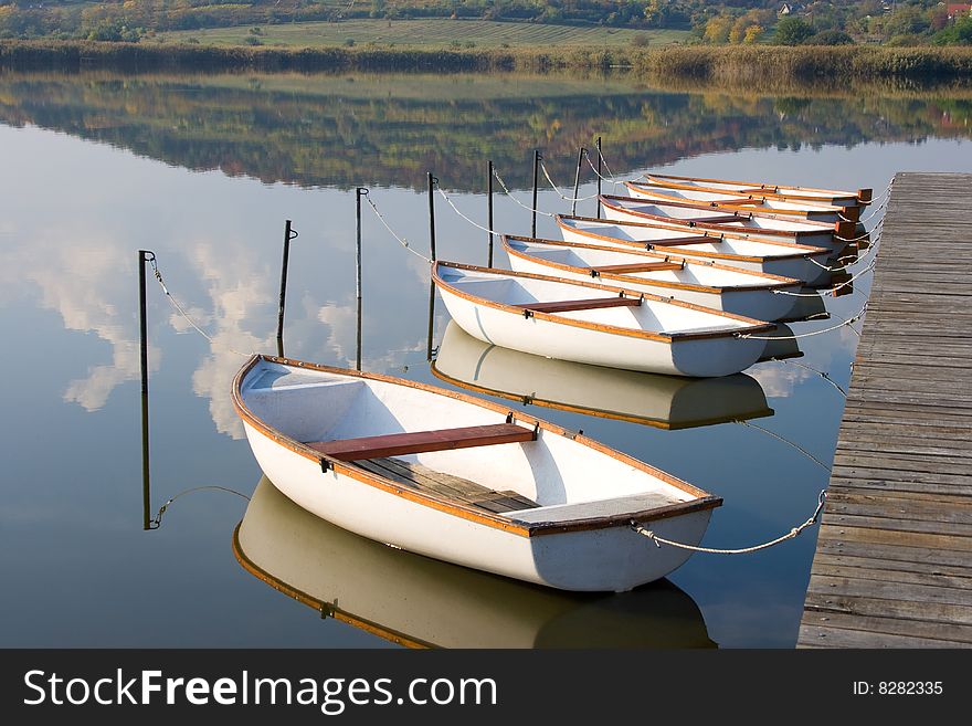 White boats on calm water surface.