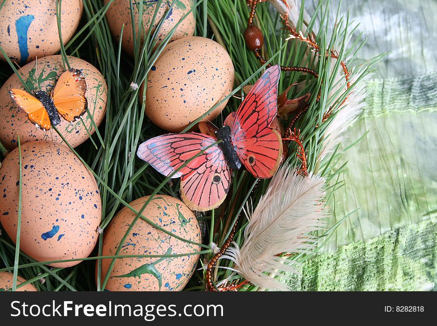 Decorated eggs in a wreath on a green background. Decorated eggs in a wreath on a green background