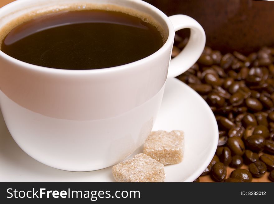 Cup of coffee and beans closeup