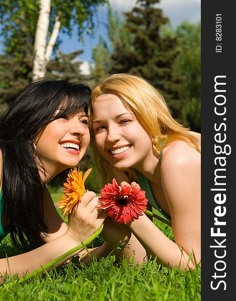 Pretty women rest in the park with flowers