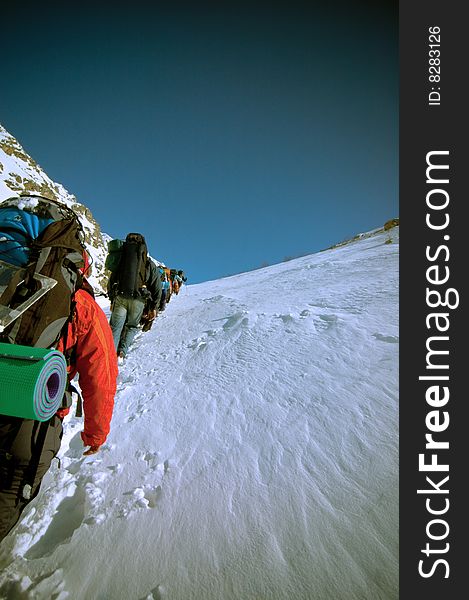 Hikers go up in mountains