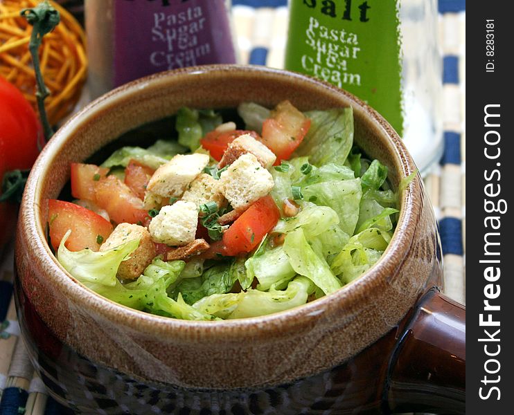 A meal of fresh salad with tomatoes and croutons
