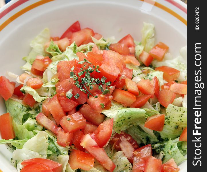 A meal of fresh salad with tomatoes and spices