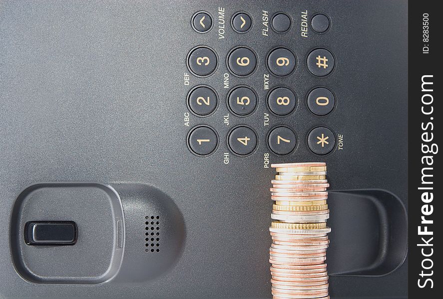 Earn by phone - coins stack with telephone as background