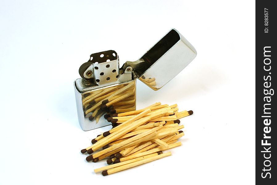 Petrol lighter against wooden sticks. Petrol lighter against wooden sticks