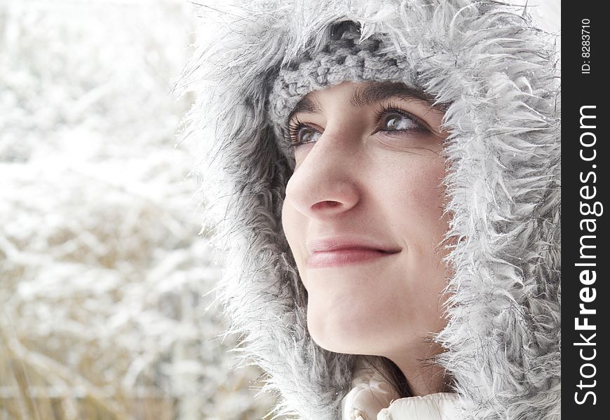 Teenage girl smiling up while out in the snow