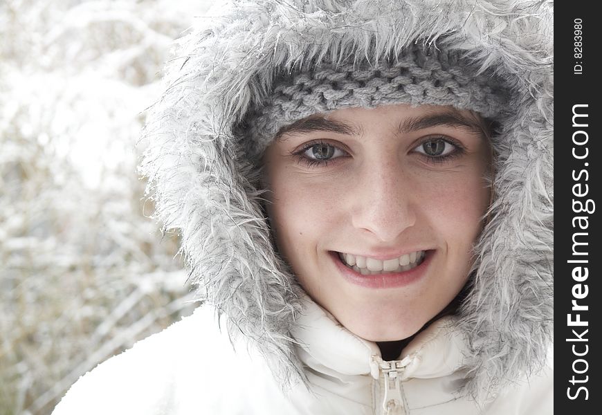 Teenage girl smiling up while out in the snow