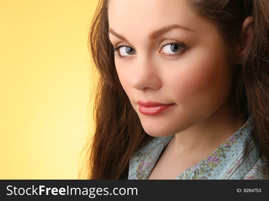 Closeup portrait of attractive young woman isolated on yellow background. Closeup portrait of attractive young woman isolated on yellow background