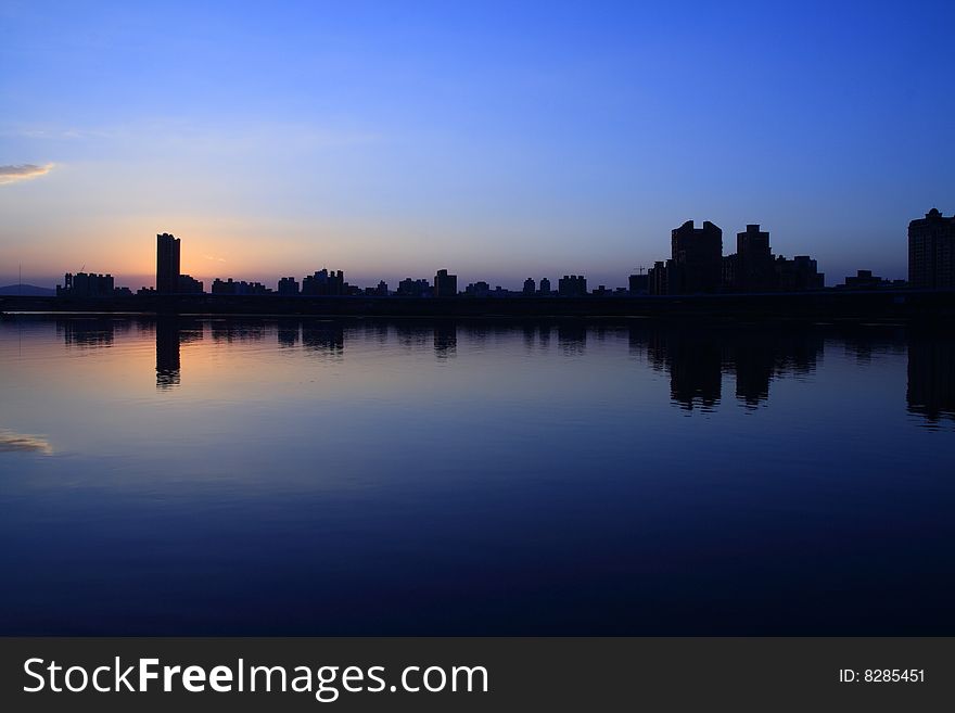 The sunsetã€skyline and an inverted reflection in water neer the dock named ManKan. The sunsetã€skyline and an inverted reflection in water neer the dock named ManKan