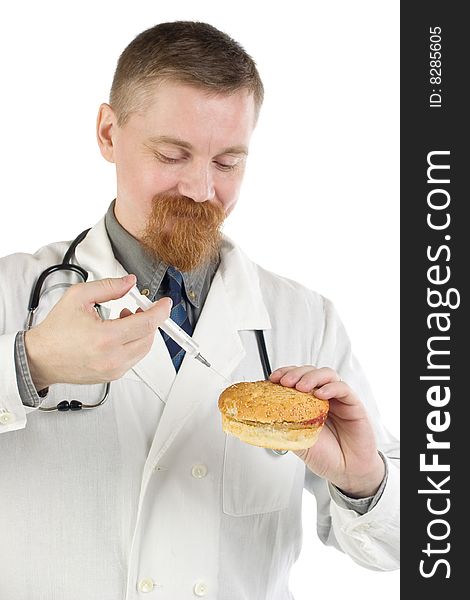 Smiling bearded doctor makes an injection into a hamburger with a syringe. Smiling bearded doctor makes an injection into a hamburger with a syringe