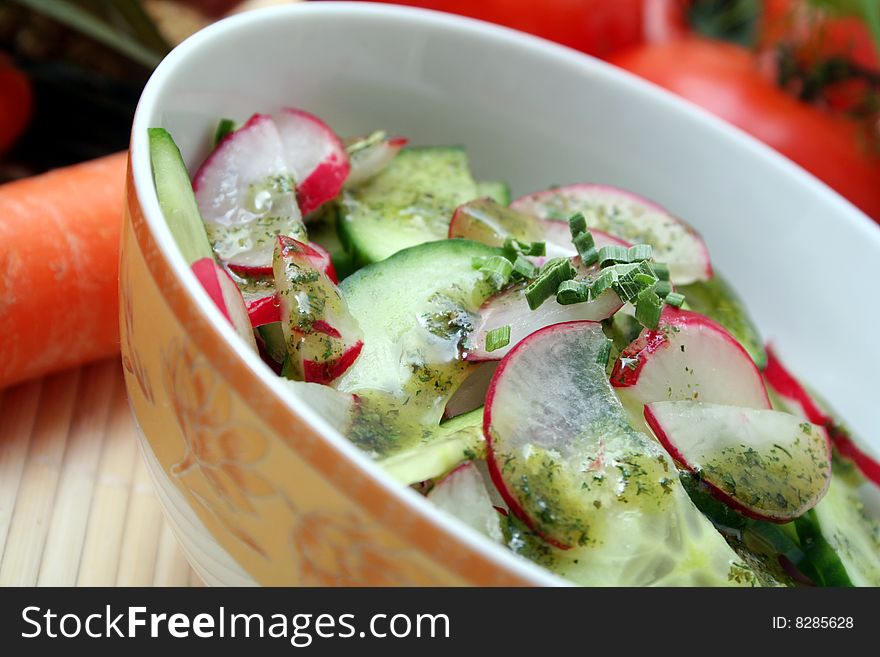 A fresh salad of cucumbers and red radish