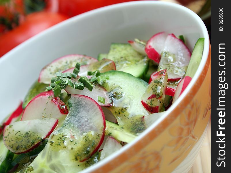 A fresh salad of cucumbers and red radish