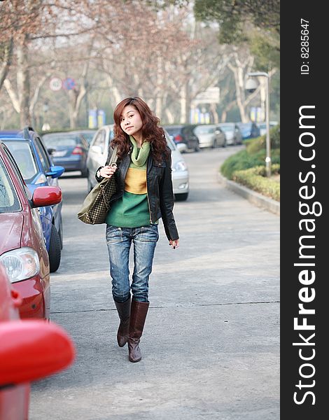 Young asian women with car in street