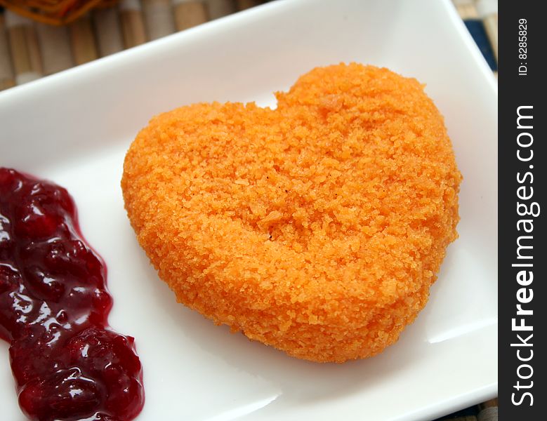 A meal of a cheese heart with fruits