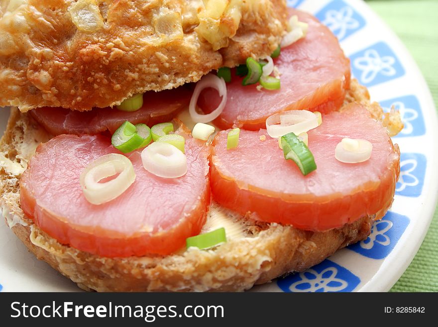 A fresh cheesebread with ham and onions. A fresh cheesebread with ham and onions