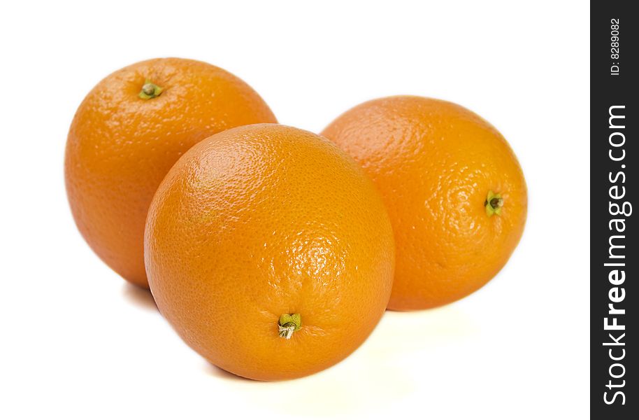 Three fresh oranges on white background