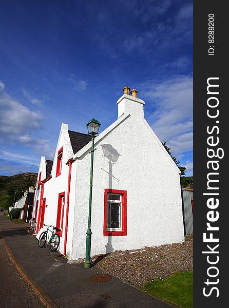 A white house in the main street of shieldaig in Scotland.