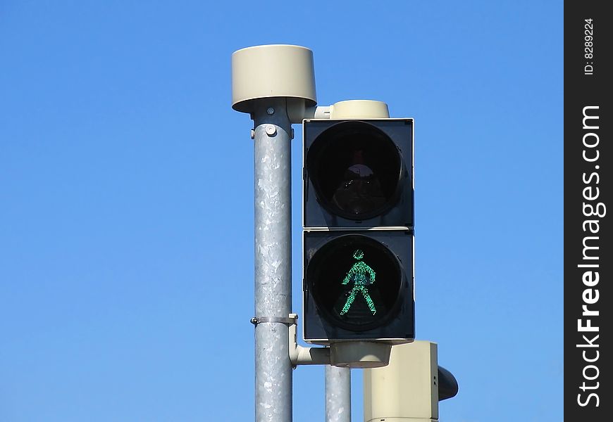 Detail of traffic lights for pedestrians with green sign for walk. Detail of traffic lights for pedestrians with green sign for walk.