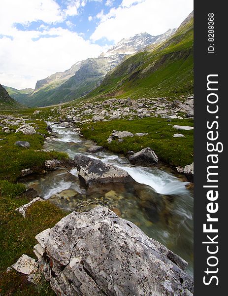 Summer day in mountain with a beautiful panorama and a torrent. Summer day in mountain with a beautiful panorama and a torrent