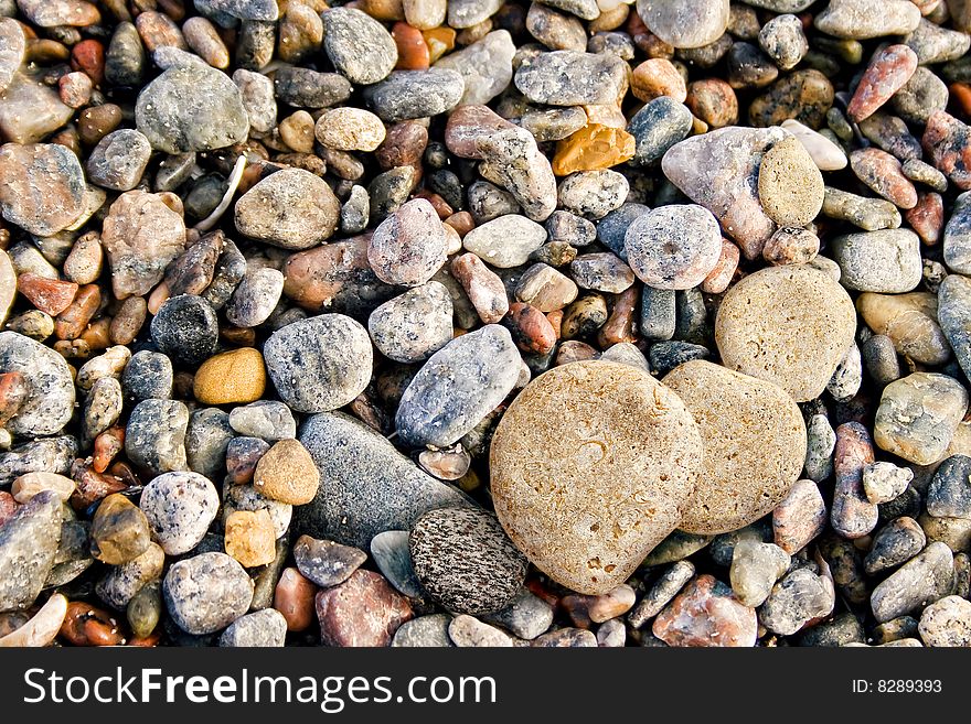 Abstract background of colorful pebbles on beach