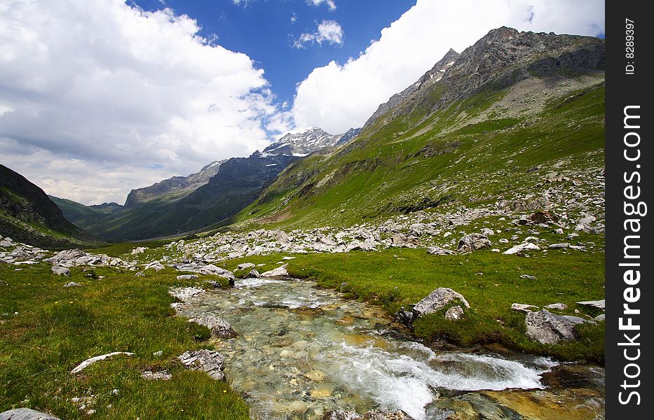 Summer day in mountains with a beautiful panorama and a nice fresh river. Summer day in mountains with a beautiful panorama and a nice fresh river