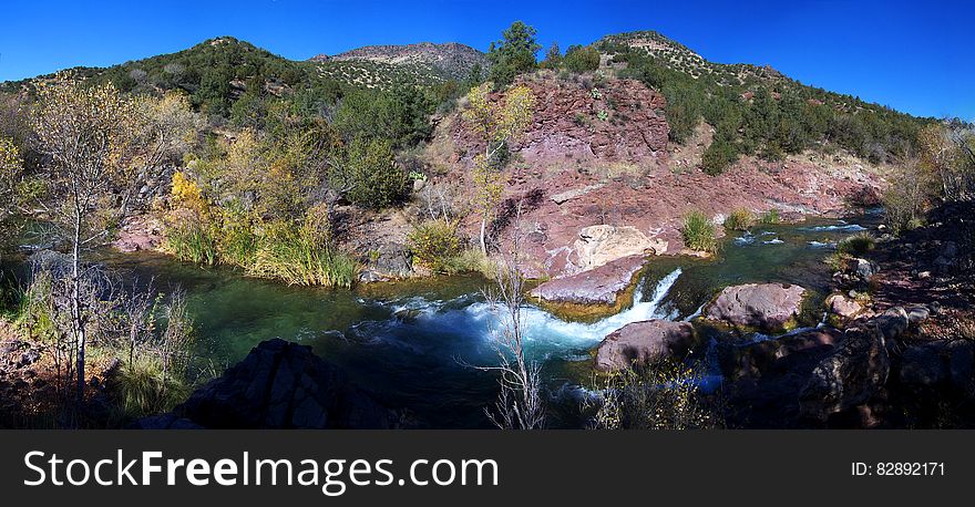 Fossil Creek just below the Irving power plant site, 2006. The power plant had been decommissioned and the structures were in the process of being removed before the creek was granted the &quot;Wild and Scenic&quot; designation in 2009. Fossil Creek is one of only two National Wild &amp; Scenic rivers in Arizona and is fed by springs coming from the cliffs of the Mogollon Rim. Over 30 million gallons of water are discharged each day at a constant 70&deg;F. The high mineral content leaves travertine dams and deposits, giving rise to fossil-like features. In 2005, Arizona Public Service &#x28;APS&#x29; decommissioned the Fossil Creek Dam and Flume, restoring full flows to Fossil Creek. The diversion dam at Fossil Springs was partially removed, allowing the creek to flow freely. The flume that once carried water to the power plant was disassembled. The Irving power plant and other buildings around the site were removed. Traces of history remain visible at the Irving site and along the Flume Trail in the form of old building foundations, rock work along the flume&#x27;s maintenance road, and concrete pilings that once supported the flume. Photo by Deborah Lee Soltesz, November 26, 2006. Credit: Coconino National Forest, U.S. Forest Service. Learn more about Fossil Creek Wild and Scenic River on the Coconino National Forest. This is a stitched panorama. Some portions of the edges &#x28;mainly the sky&#x29; were edited to fill in areas that were not photographed. Fossil Creek just below the Irving power plant site, 2006. The power plant had been decommissioned and the structures were in the process of being removed before the creek was granted the &quot;Wild and Scenic&quot; designation in 2009. Fossil Creek is one of only two National Wild &amp; Scenic rivers in Arizona and is fed by springs coming from the cliffs of the Mogollon Rim. Over 30 million gallons of water are discharged each day at a constant 70&deg;F. The high mineral content leaves travertine dams and deposits, giving rise to fossil-like features. In 2005, Arizona Public Service &#x28;APS&#x29; decommissioned the Fossil Creek Dam and Flume, restoring full flows to Fossil Creek. The diversion dam at Fossil Springs was partially removed, allowing the creek to flow freely. The flume that once carried water to the power plant was disassembled. The Irving power plant and other buildings around the site were removed. Traces of history remain visible at the Irving site and along the Flume Trail in the form of old building foundations, rock work along the flume&#x27;s maintenance road, and concrete pilings that once supported the flume. Photo by Deborah Lee Soltesz, November 26, 2006. Credit: Coconino National Forest, U.S. Forest Service. Learn more about Fossil Creek Wild and Scenic River on the Coconino National Forest. This is a stitched panorama. Some portions of the edges &#x28;mainly the sky&#x29; were edited to fill in areas that were not photographed.