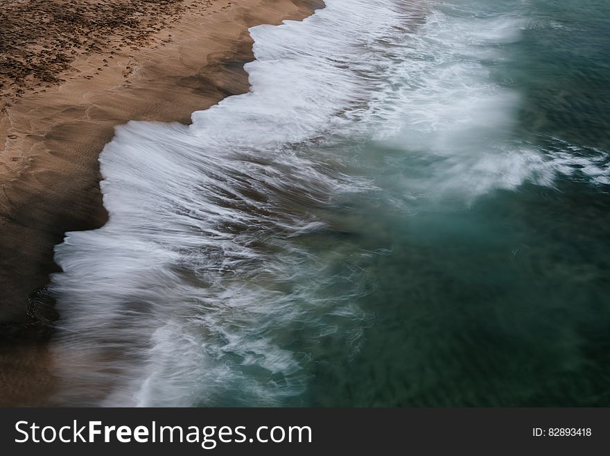 Waves splashing on the sandy shores of the ocean. Waves splashing on the sandy shores of the ocean.