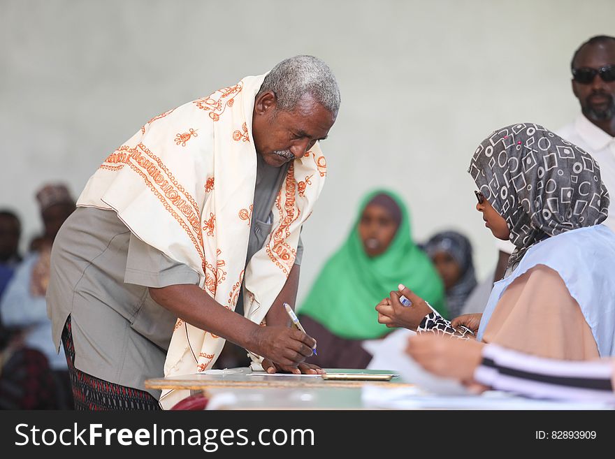 An electoral official verifies the identity of a delegate during the electoral process to choose members of the Lower House of the of the Somali federal Parliament in Garowe, Somalia on November 23, 2016. UN Photo. An electoral official verifies the identity of a delegate during the electoral process to choose members of the Lower House of the of the Somali federal Parliament in Garowe, Somalia on November 23, 2016. UN Photo