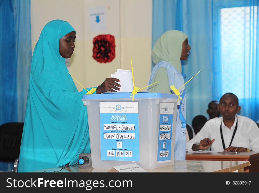 A delegate casts her vote during the electoral process to choose members of the Lower House of the Somali federal Parliament in Baidoa, Somalia on November 23, 2016. AMISOM Photo/ Sabir Olad. A delegate casts her vote during the electoral process to choose members of the Lower House of the Somali federal Parliament in Baidoa, Somalia on November 23, 2016. AMISOM Photo/ Sabir Olad