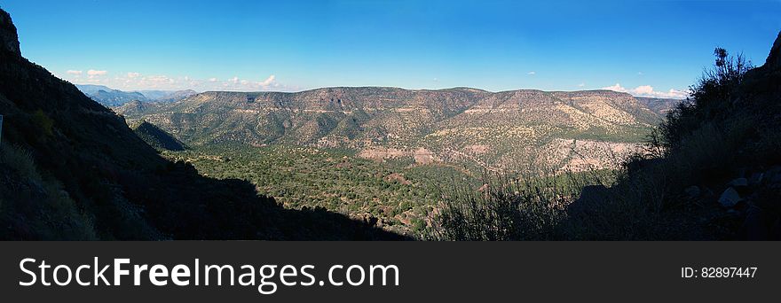 View of the canyon above Fossil Creek from Fossil Creek Road &#x28;FR 708&#x29; in 2006. The flume &#x28;now removed&#x29; that once fed water from the diversion dam at the springs to the Irving power plant is visible running along the length of the canyon. This section of road is currently &#x28;2016&#x29; closed due to safety issues caused by rock falls along the cliff above the road. Fossil Creek is one of only two National Wild &amp; Scenic rivers in Arizona and is fed by springs coming from the cliffs of the Mogollon Rim. Over 30 million gallons of water are discharged each day at a constant 70&deg;F. The high mineral content leaves travertine dams and deposits, giving rise to fossil-like features. In 2005, Arizona Public Service &#x28;APS&#x29; decommissioned the Fossil Creek Dam and Flume, restoring full flows to Fossil Creek. The diversion dam at Fossil Springs was partially removed, allowing the creek to flow freely. The flume that once carried water to the power plant was disassembled. The Irving power plant and other buildings around the site were removed. Traces of history remain visible at the Irving site and along the Flume Trail in the form of old building foundations, rock work along the flume&#x27;s maintenance road, and concrete pilings that once supported the flume. Photo by Deborah Lee Soltesz, November 26, 2006. Credit: Coconino National Forest, U.S. Forest Service. Learn more about Fossil Creek Wild and Scenic River on the Coconino National Forest. This is a stitched panorama. Some portions of the edges &#x28;mainly the sky&#x29; were edited to fill in areas that were not photographed. View of the canyon above Fossil Creek from Fossil Creek Road &#x28;FR 708&#x29; in 2006. The flume &#x28;now removed&#x29; that once fed water from the diversion dam at the springs to the Irving power plant is visible running along the length of the canyon. This section of road is currently &#x28;2016&#x29; closed due to safety issues caused by rock falls along the cliff above the road. Fossil Creek is one of only two National Wild &amp; Scenic rivers in Arizona and is fed by springs coming from the cliffs of the Mogollon Rim. Over 30 million gallons of water are discharged each day at a constant 70&deg;F. The high mineral content leaves travertine dams and deposits, giving rise to fossil-like features. In 2005, Arizona Public Service &#x28;APS&#x29; decommissioned the Fossil Creek Dam and Flume, restoring full flows to Fossil Creek. The diversion dam at Fossil Springs was partially removed, allowing the creek to flow freely. The flume that once carried water to the power plant was disassembled. The Irving power plant and other buildings around the site were removed. Traces of history remain visible at the Irving site and along the Flume Trail in the form of old building foundations, rock work along the flume&#x27;s maintenance road, and concrete pilings that once supported the flume. Photo by Deborah Lee Soltesz, November 26, 2006. Credit: Coconino National Forest, U.S. Forest Service. Learn more about Fossil Creek Wild and Scenic River on the Coconino National Forest. This is a stitched panorama. Some portions of the edges &#x28;mainly the sky&#x29; were edited to fill in areas that were not photographed.