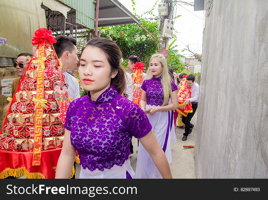 Asian tradition with people carrying tables of gold boxes.