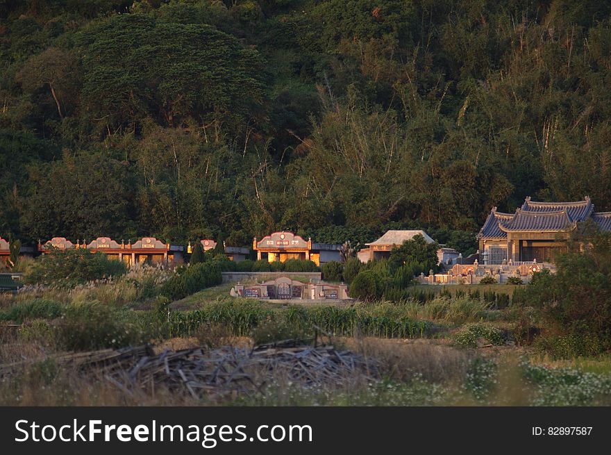 A traditional Asian village by the woods and the hills.