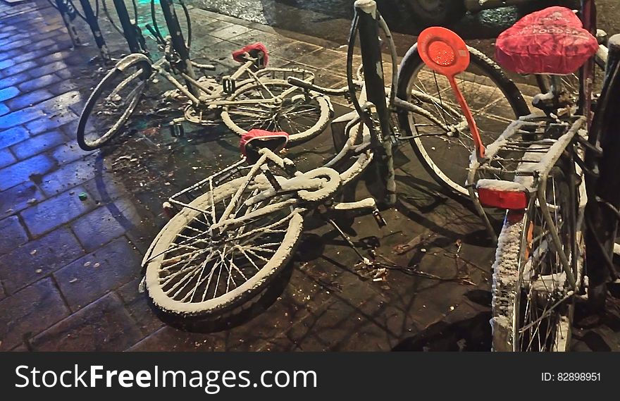 Snow Covered Bicycles On Streets