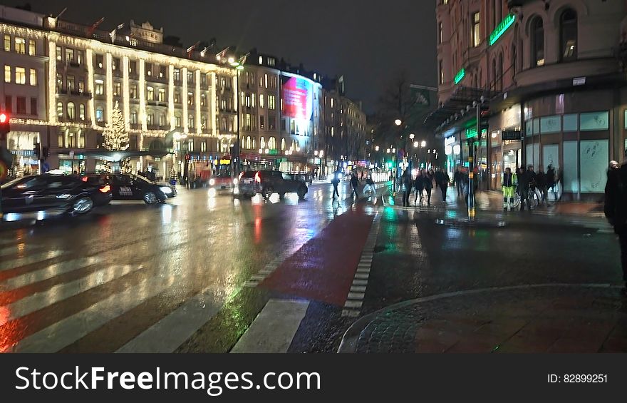 Nighttime scene of urban street illuminated with traffic. Nighttime scene of urban street illuminated with traffic.