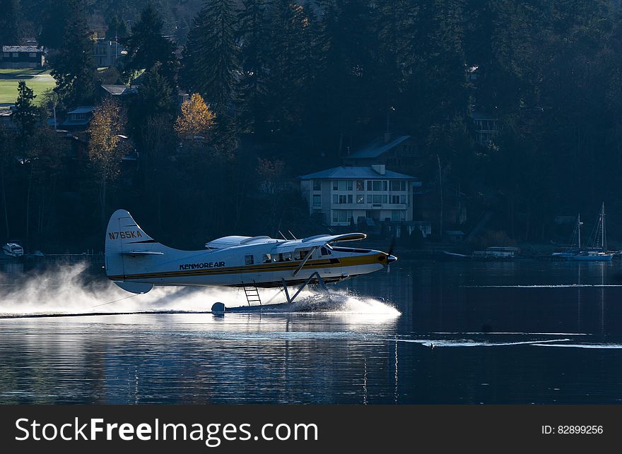 Seaplane on take off or landing on sunny day. Seaplane on take off or landing on sunny day.