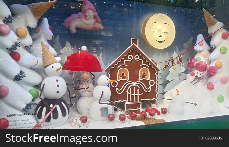 Gingerbread house and snow men in wintry Christmas display. Gingerbread house and snow men in wintry Christmas display.
