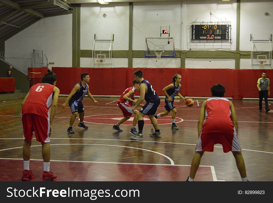 Players during basketball game on indoor gymnasium court. Players during basketball game on indoor gymnasium court.