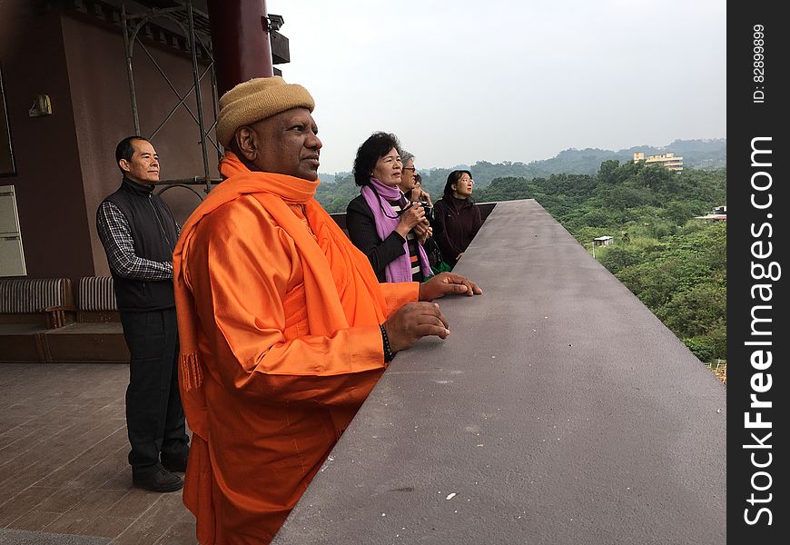 Tourists standing outdoors on balcony overlook or observation deck at rural countryside. Tourists standing outdoors on balcony overlook or observation deck at rural countryside.