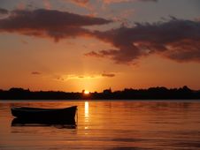 Dinghy Silhouetted In Sunrise Over The Bay. Stock Image Dinghy Silhouetted In Sunrise Over The Bay. Stock Image