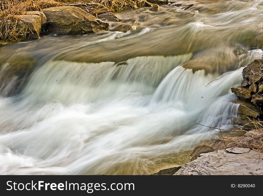 Fast moving running water from a lake running over rocks. Fast moving running water from a lake running over rocks