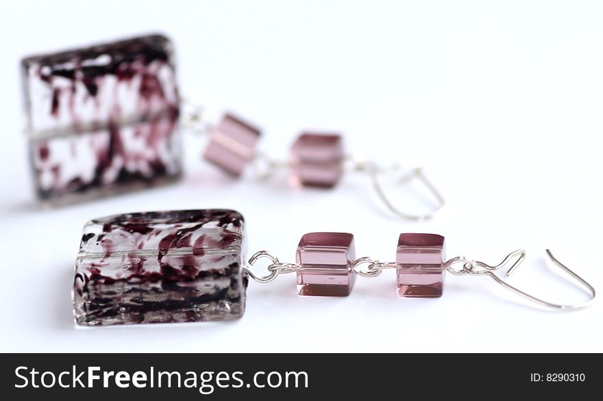 Violet earrings made by lampwork square and cubes on white background