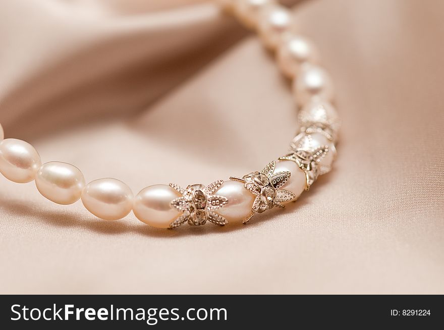 Beads of pearl on the light-coloured background